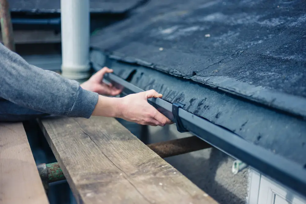 hands inspecting gutters