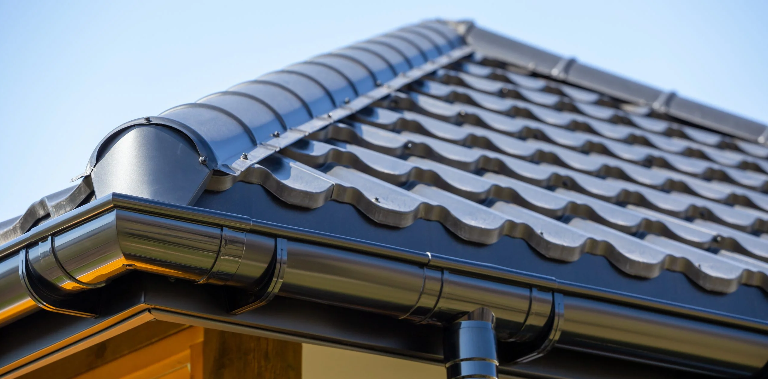 Corner of new tile roof and colorbond gutters
