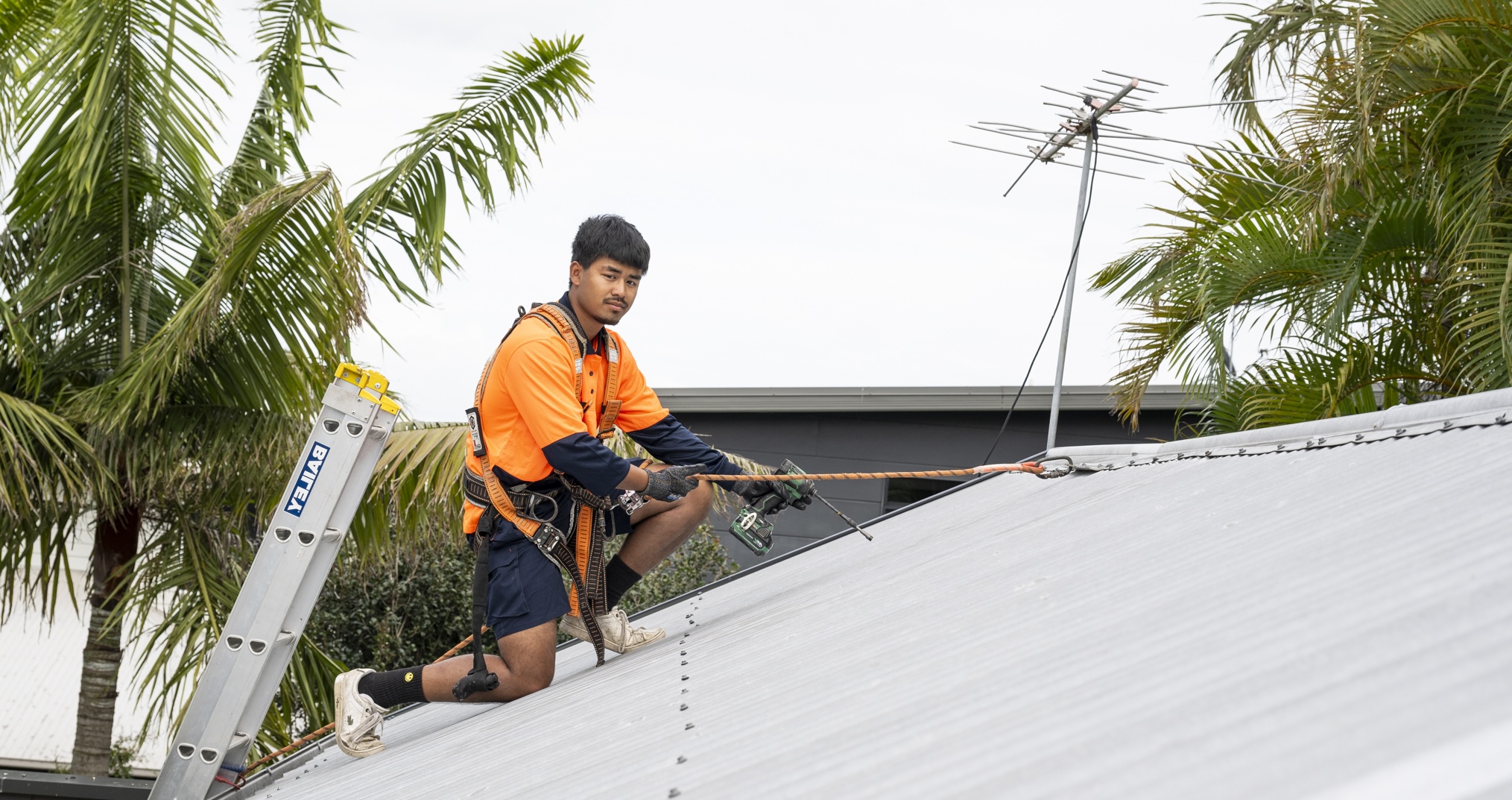 Gutter and Roof Repairs roofer repairing metal roof