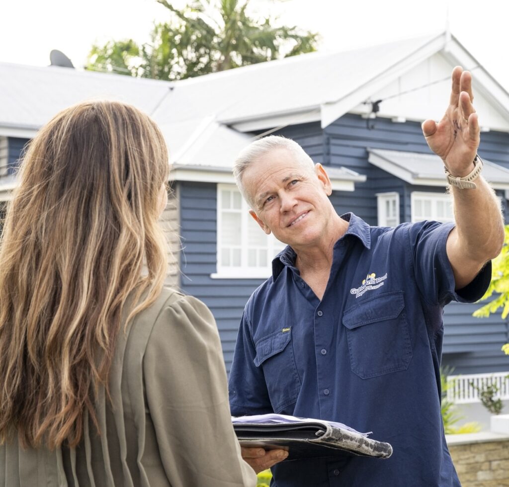 Jason Wilson of Gutter and Roof Repairs talking to a home owner